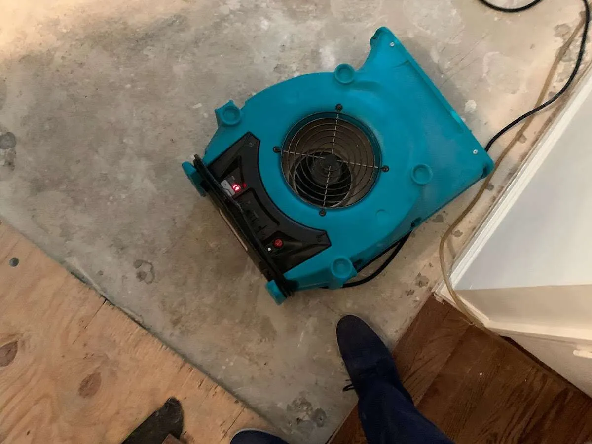 Air mover drying subfloor during Commercial Water Damage Restoration in Holmen